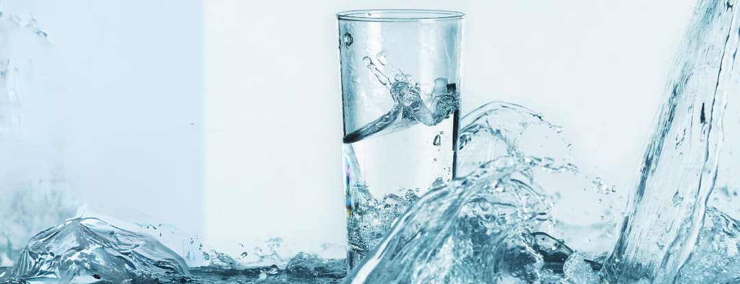 glass of water with water splashing